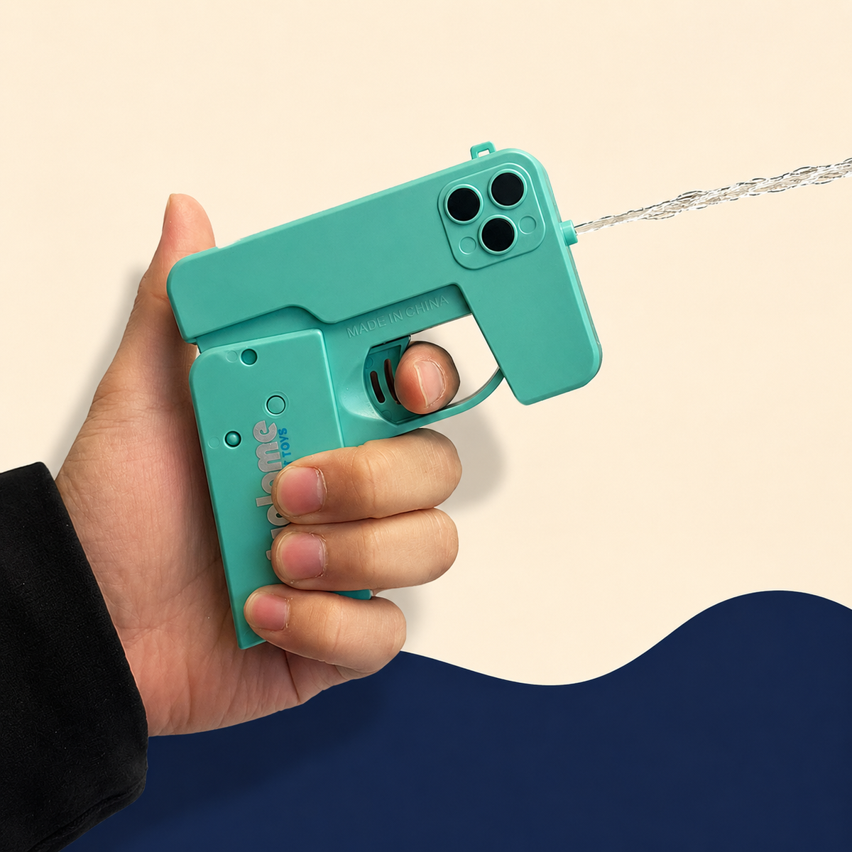 Foldable water gun showing its spray nozzle and trigger