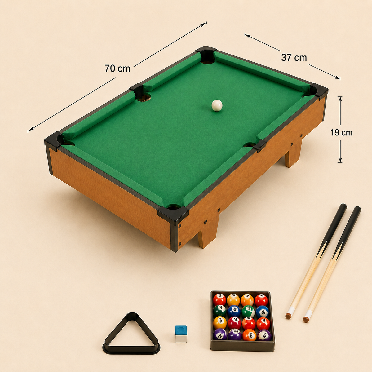 A miniature pool table set shown on a light beige background with dimension arrows and labels. The set includes a small green felt table with a wood-look frame, a white cue ball, two cue sticks, a black triangle rack, a small chalk holder, and a rack of colorful billiard balls.