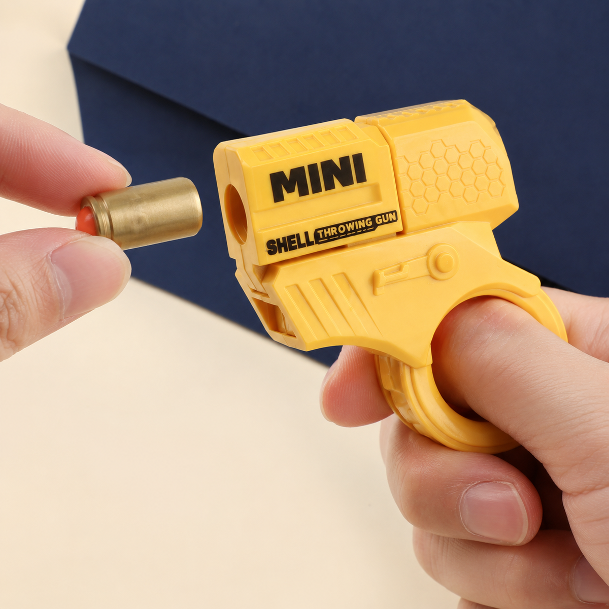 Mini shell-ejecting ring blaster worn correctly on a finger