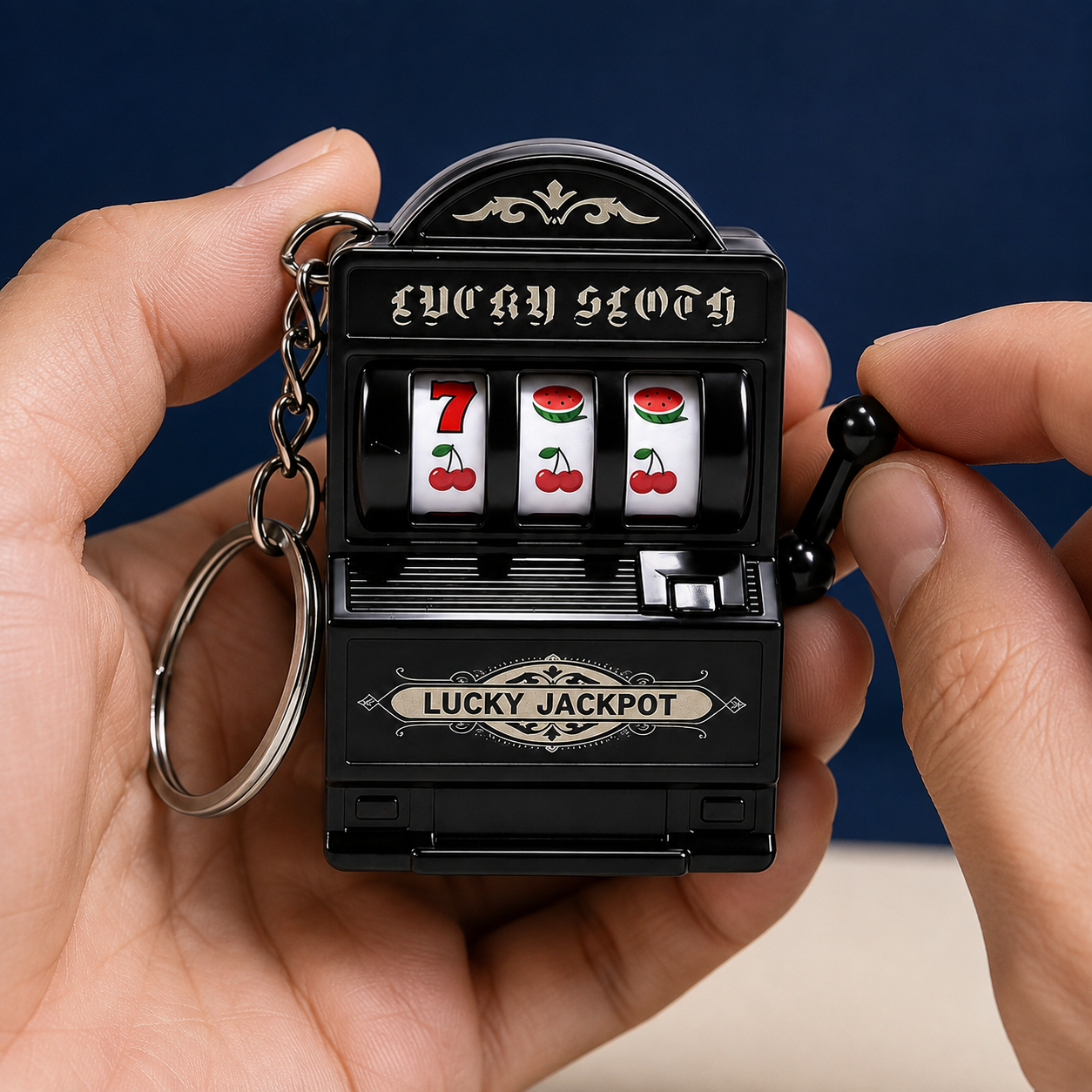 Hand pulling the lever on a mini slot machine keychain